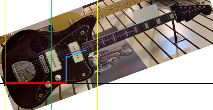 Shows ergonomic measurements for a Jazzmasterr guitar played while sitting or standing